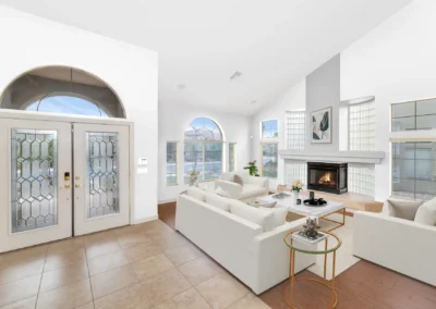 Virtually staged living room with white walls, modern furniture, and decor for a US real estate listing.