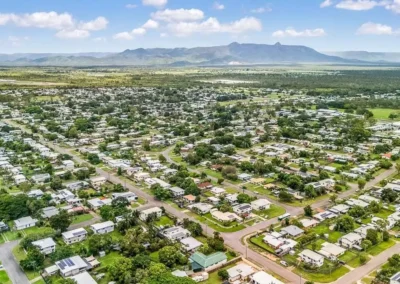 Wide-angle aerial drone shot of a residential area, professionally edited for real estate agents.
