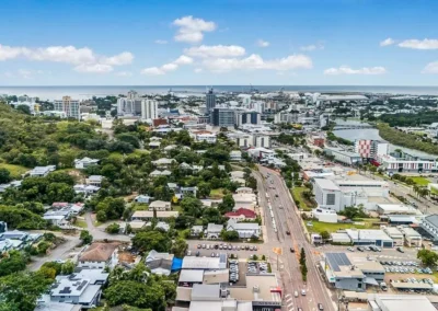 Wide-angle aerial drone shot of city skyline and urban development for real estate marketing.